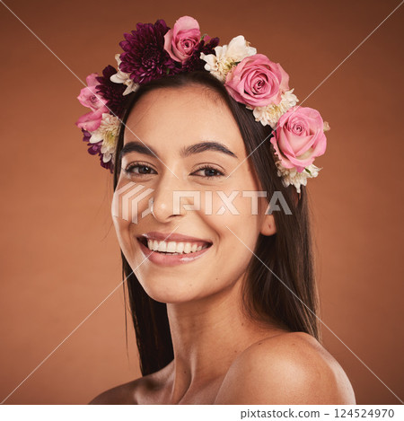 Woman, beauty smile and flower headband for spring portrait. Young happy girl, natural cosmetic makeup and healthy facial skincare wellness glow with floral rose band in orange background studio 124524970