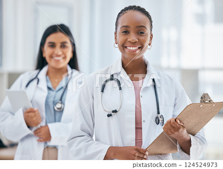 Healthcare, women and doctors with patient chart on clipboard in hospital or clinic. Happy black woman doctor, medical partnership and insurance documents, diversity and leadership in health care. Healthcare, women and doctors with patient chart on clipboard in hospital or clinic. Happy black woman doctor, medical partnership and insurance documents, diversity and leadership in health care. 124524973