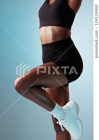 Stretching, body and abs of a woman training, doing fitness and exercise against a blue mockup studio background. Stomach, workout and wellness for an athlete doing a warm up for sport with legs 124524988