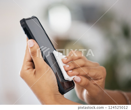 Tissue, screen and hands of a person with a phone for clean, safety and free from virus. Cleaning, covid and worker with a cloth to disinfect technology, mobile or smartphone for health at work 124525012
