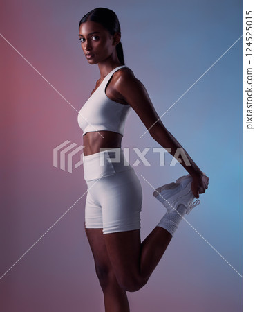 Fitness, stretching leg and exercise woman training for health, wellness and strong body in studio background. Workout performance and athlete warm up body with motivation, commitment and focus Fitness, stretching leg and exercise woman training for health, wellness and strong body in studio background. Workout performance and athlete warm up body with motivation, commitment and focus 124525015