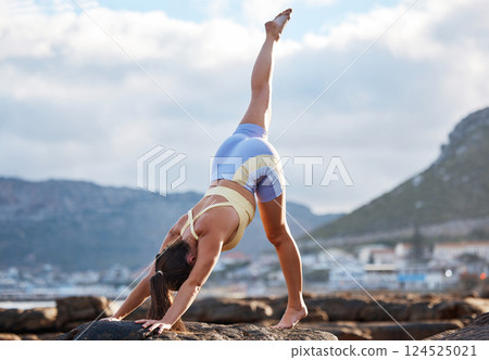 Yoga, woman and leg stretching in city nature outdoors for mental health and body wellness. Young healthy zen fitness person, calm meditation stretch and pilates lifestyle motivation on beach rocks 124525021