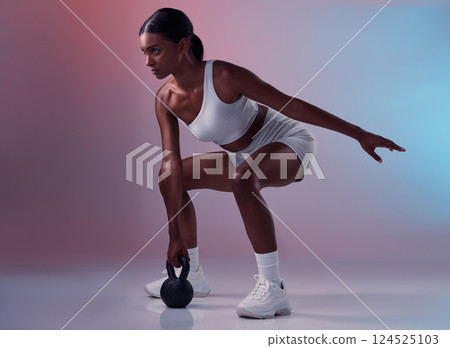 Fitness, kettlebell and woman training in studio for full body balance, powerful muscles and strong arms. Sports, exercise and healthy Indian girl swinging weights or weightlifting in a squat pose Fitness, kettlebell and woman training in studio for full body balance, powerful muscles and strong arms. Sports, exercise and healthy Indian girl swinging weights or weightlifting in a squat pose 124525103