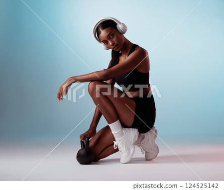 Headphones, fitness and kettlebell black woman in studio portrait for workout music, body training or wellness audio. Gym, exercise and health girl in sports fashion marketing or advertising mock up Headphones, fitness and kettlebell black woman in studio portrait for workout music, body training or wellness audio. Gym, exercise and health girl in sports fashion marketing or advertising mock up 124525142