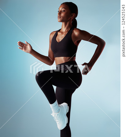 Running, cardio and woman training for fitness, energy and wellness against a blue mockup studio background. Exercise, sprint and girl runner doing a workout, walking or focus on a body goal 124525143