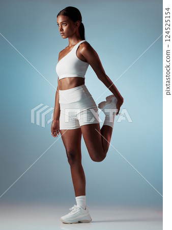 Leg, stretching and woman thinking of fitness, motivation and body performance against a blue studio background. Training, sports and girl with focus and balance with a warm up for start of workout Leg, stretching and woman thinking of fitness, motivation and body performance against a blue studio background. Training, sports and girl with focus and balance with a warm up for start of workout 124525154
