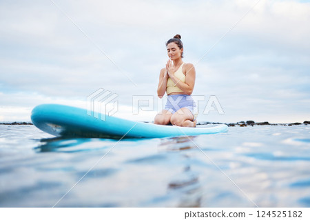 Yoga meditation, ocean and surfer woman meditating for health wellness, peace or freedom on sea water. Surfboard pilates, prayer and zen girl meditate for beach fitness, aura or chakra energy healing 124525182