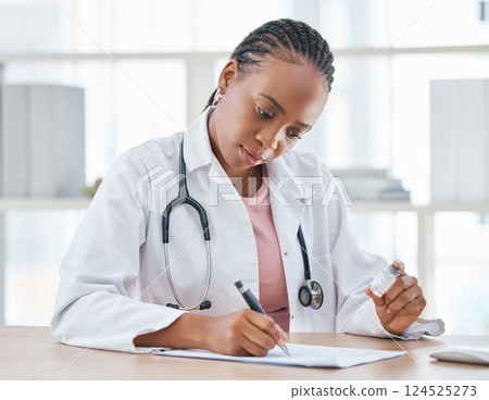 Medicine, vaccine and doctor writing notes in her office while while preparing a vial for a patient, Healthcare, vaccination syringe and black woman doing inspection on a medical product in hospital. 124525273