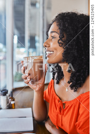 Coffee shop, thinking and writing with a black woman freelancer drinking a beverage with an idea in mind. Cafe, book and creative with a young female customer enjoying freedom in a restaurant 124525405