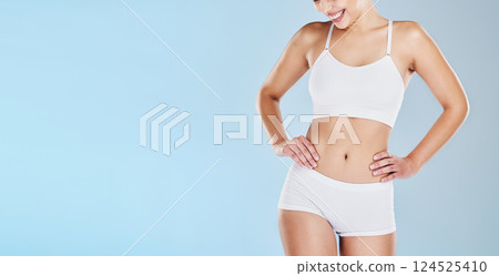 Health, body and mockup with a model women in underwear on a blue background in studio to promote weightloss. Fitness, wellness and diet with a happy female posing for a healthy lifestyle 124525410