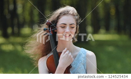 Portrait of a young girl with her violin. 124525434
