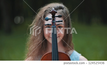 Portrait of a young girl with her violin. Portrait of a young girl with her violin. 124525436