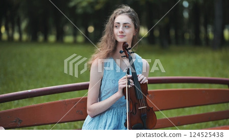 Portrait of a young girl with her violin. Portrait of a young girl with her violin. 124525438