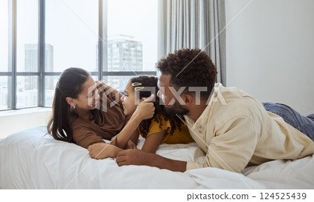 Happy family, relax and girl in bed with mother and father, bond and resting in their home together. Love, black family and child enjoy lazy morning indoors with parents, rest and embrace in bedroom 124525439