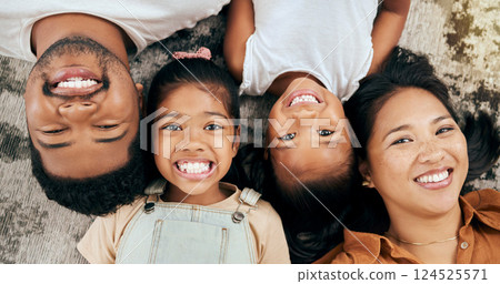 Happy, smile and portrait of family on floor with top view for care, wellness and bonding in living room. Relax, youth and lifestyle with parents and children lying on ground of home for support 124525571