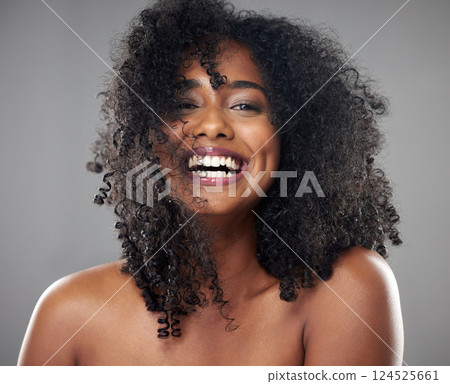 Face, hair care and beauty smile of black woman on gray studio background. Portrait, makeup and female model from Jamaica with beautiful, healthy head of hair and curls after spa cosmetics treatment Face, hair care and beauty smile of black woman on gray studio background. Portrait, makeup and female model from Jamaica with beautiful, healthy head of hair and curls after spa cosmetics treatment 124525661