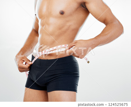 Health, diet and body of man with tape measure to check progress, fitness results and measure stomach waist. Weight loss goals, wellness mindset motivation and underwear model on white background Health, diet and body of man with tape measure to check progress, fitness results and measure stomach waist. Weight loss goals, wellness mindset motivation and underwear model on white background 124525675
