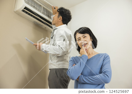 Workers inspecting air conditioners Workers inspecting air conditioners 124525697