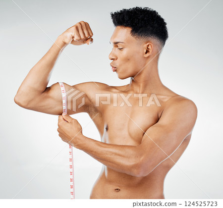 Fitness, biceps and man with measuring tape on arm, check muscle growth and development in training exercise. Workout, gym and happy healthy bodybuilder measuring bicep muscles, health and wellness. Fitness, biceps and man with measuring tape on arm, check muscle growth and development in training exercise. Workout, gym and happy healthy bodybuilder measuring bicep muscles, health and wellness. 124525723
