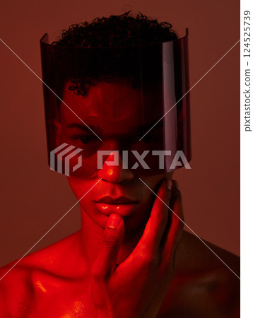 Cyberpunk, glasses and man in red studio, lighting, model and fashion in the future. Dark, tech and face portrait of male with futuristic, edgy and modern style with visor for cyber punk aesthetic Cyberpunk, glasses and man in red studio, lighting, model and fashion in the future. Dark, tech and face portrait of male with futuristic, edgy and modern style with visor for cyber punk aesthetic 124525739