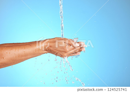 Hands, water and woman in studio for cleaning, washing hands and safety from bacteria against a blue background. Hand, splash and model washing for skincare, hygiene and germ prevention with mockup 124525741