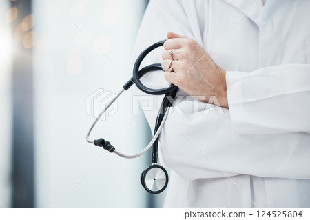 Senior doctor, hands and stethoscope in hospital ready for diagnosis, check up or heart health closeup. Healthcare, expert or cardiologist holding equipment for cardiology exam in doctors office. 124525804