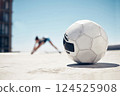 Soccer ball, sport and fitness, training and exercise, sports workout and athlete stretching, prepare for football outdoor in urban town. Soccer, healthy and active lifestyle, cardio and endurance. 124525908