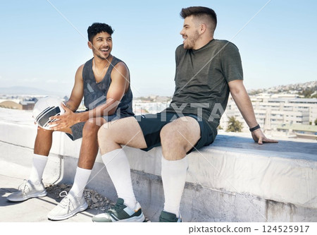 Friends, sports and talking after soccer game on rooftop for urban sports, exercise and training outdoor in summer. Athlete men have conversation about fitness, football and city lifestyle with ball 124525917