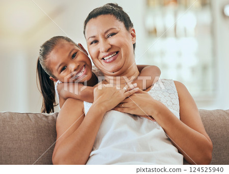 Love, hug and grandmother portrait with granddaughter bonding at home on the living room sofa. Mature woman embracing and hugging or cuddling with her little grandkid for relaxing care and bond Love, hug and grandmother portrait with granddaughter bonding at home on the living room sofa. Mature woman embracing and hugging or cuddling with her little grandkid for relaxing care and bond 124525940