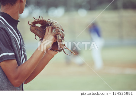 Baseball, sports and a pitcher throwing a ball during a competitive game or match on a grass pitch field. Fitness, exercise and sport with a man baseball player playing in a competitive outdoor event 124525991