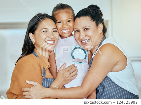 Mother, girl and grandma in hug kitchen with smile on face and help baking or cooking together. Family, apron and generations, portrait of happy women and child hugging in family home in Indonesia. 124525992