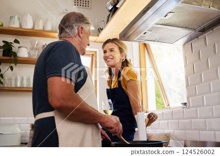 Cooking, wine and senior couple talking in the kitchen of a house while preparing dinner together. Happy, smile and elderly man and woman in communication with food and glass of alcohol in a home Cooking, wine and senior couple talking in the kitchen of a house while preparing dinner together. Happy, smile and elderly man and woman in communication with food and glass of alcohol in a home 124526002