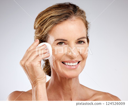 Cotton pad, senior woman skincare and beauty, natural cleaning cosmetics or facial wellness on studio background. Portrait mature model, face product and aesthetic health, makeup and body dermatology 124526009