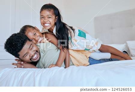 Happy family, dad and girl kids on bed in home with smile, portrait father and children play together in Asia. Love, fun and family time for dad and daughters in bedroom in family home in Indonesia 124526053