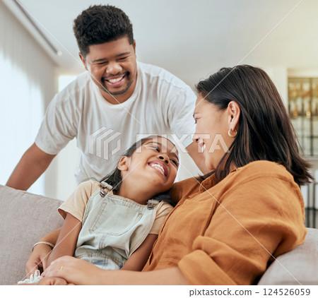 Family, mother and daughter hug with father standing at lounge sofa in Philippines home. Love, care and affection embrace of filipino mom bonding with happy child on couch in living room. Family, mother and daughter hug with father standing at lounge sofa in Philippines home. Love, care and affection embrace of filipino mom bonding with happy child on couch in living room. 124526059