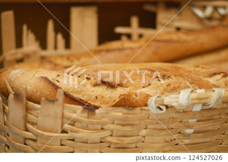Freshly baked bread in a rustic woven basket at the bakery Freshly baked bread in a rustic woven basket at the bakery 124527026