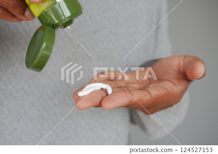 Applying cream to hand for skincare routine Applying cream to hand for skincare routine 124527153