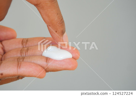 Applying moisturizer to hand with fingertip technique Applying moisturizer to hand with fingertip technique 124527224