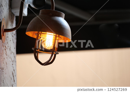 Warm light illuminating rustic lamp on a modern terrace Warm light illuminating rustic lamp on a modern terrace 124527269