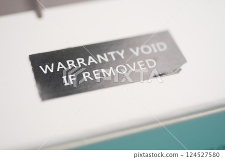 Warranty sticker on product packaging highlights important information 124527580