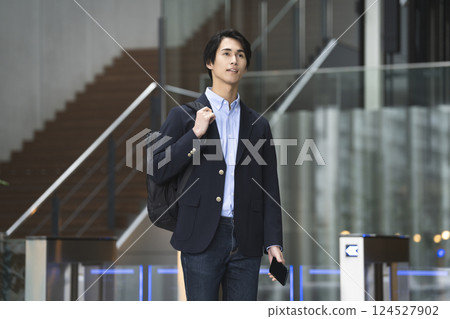 Young businessman walking with a smartphone, commuting to and from work image Young businessman walking with a smartphone, commuting to and from work image 124527902