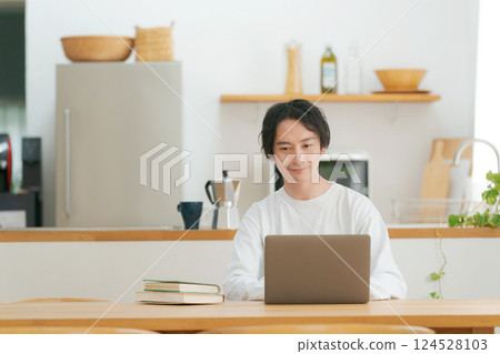 A man who uses a personal computer in the living room 124528103