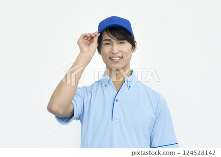 A man in his late 20s wearing a blue polo shirt looking at the camera Image of a worker/facility staff A man in his late 20s wearing a blue polo shirt looking at the camera Image of a worker/facility staff 124528142