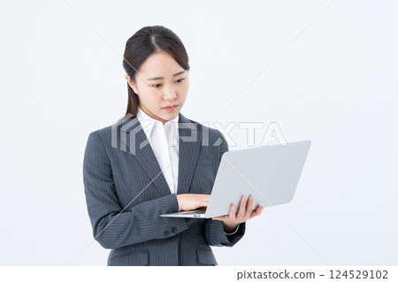 Young business woman using a computer Young business woman using a computer 124529102