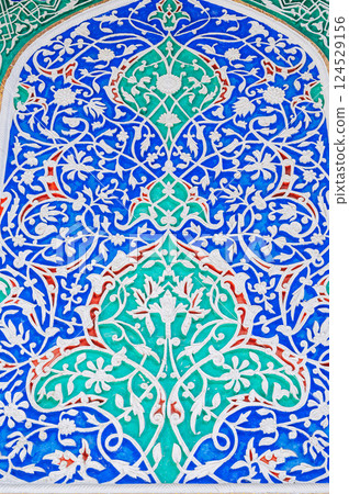 beautiful background of carved wooden painted wall in the Museum of Art of Uzbekistan with traditional Uzbek ornaments and colorful oriental patterns in Tashkent 124529156