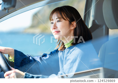 A woman driving a car 124529869