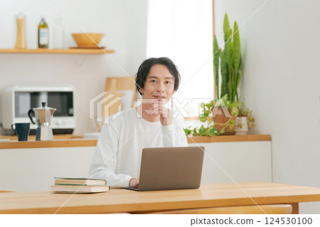 A man who uses a personal computer in the living room 124530100
