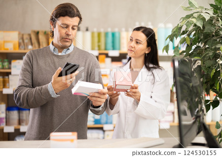 Man scans QR code on box pills label. Female pharmacist offers to choose right shampoo 124530155