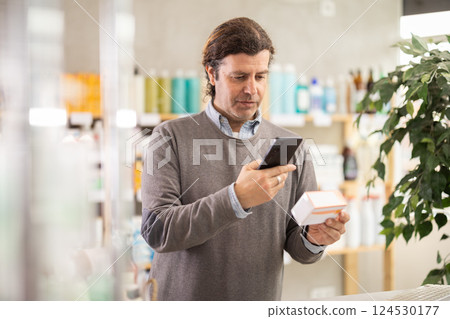 Man scans code on package of pills to check expiration date 124530177