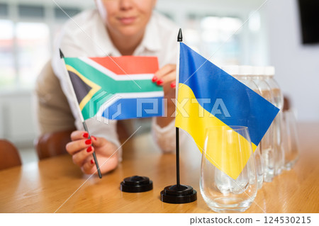 National flags of Ukraine and South Africa placed on table in meeting room 124530215